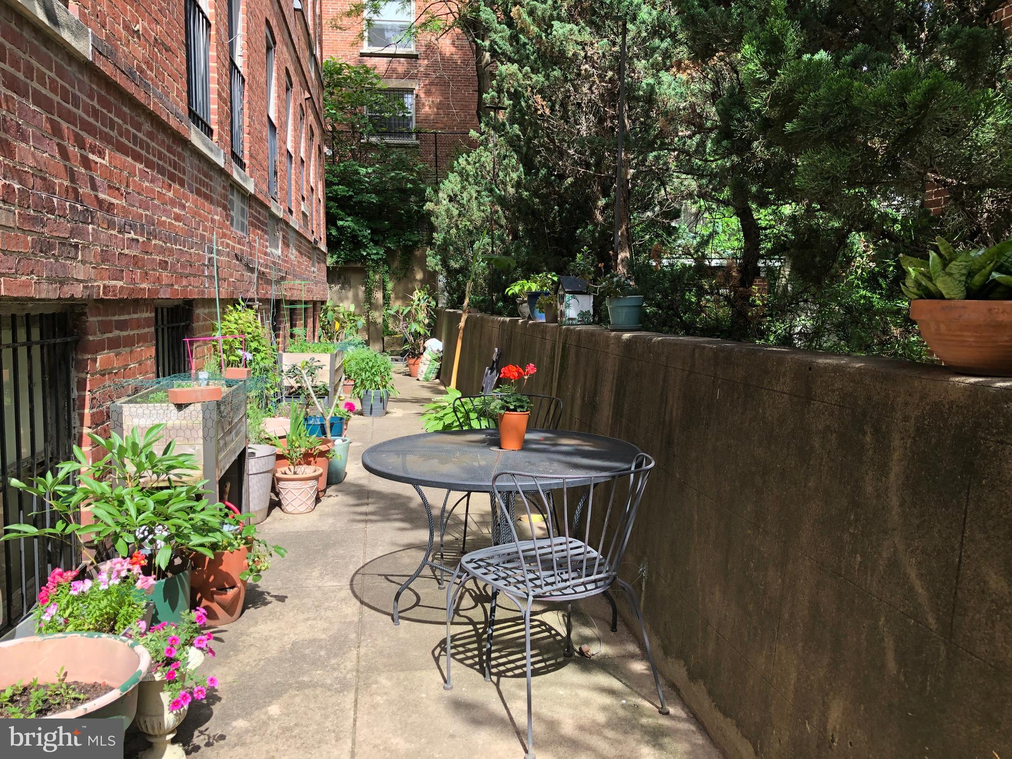 2415 20th Street Northwest, Unit 38 Washington, DC 20009 - Photo 25 of 30 a backyard of a house with outdoor seating