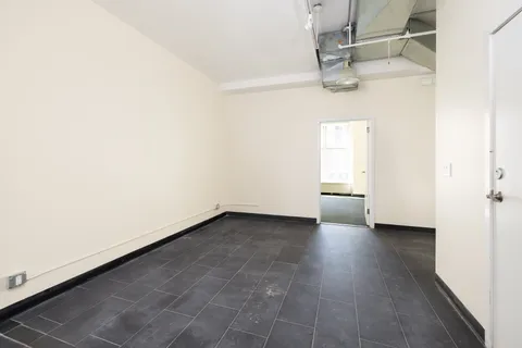 a view of a room with wooden floor and window