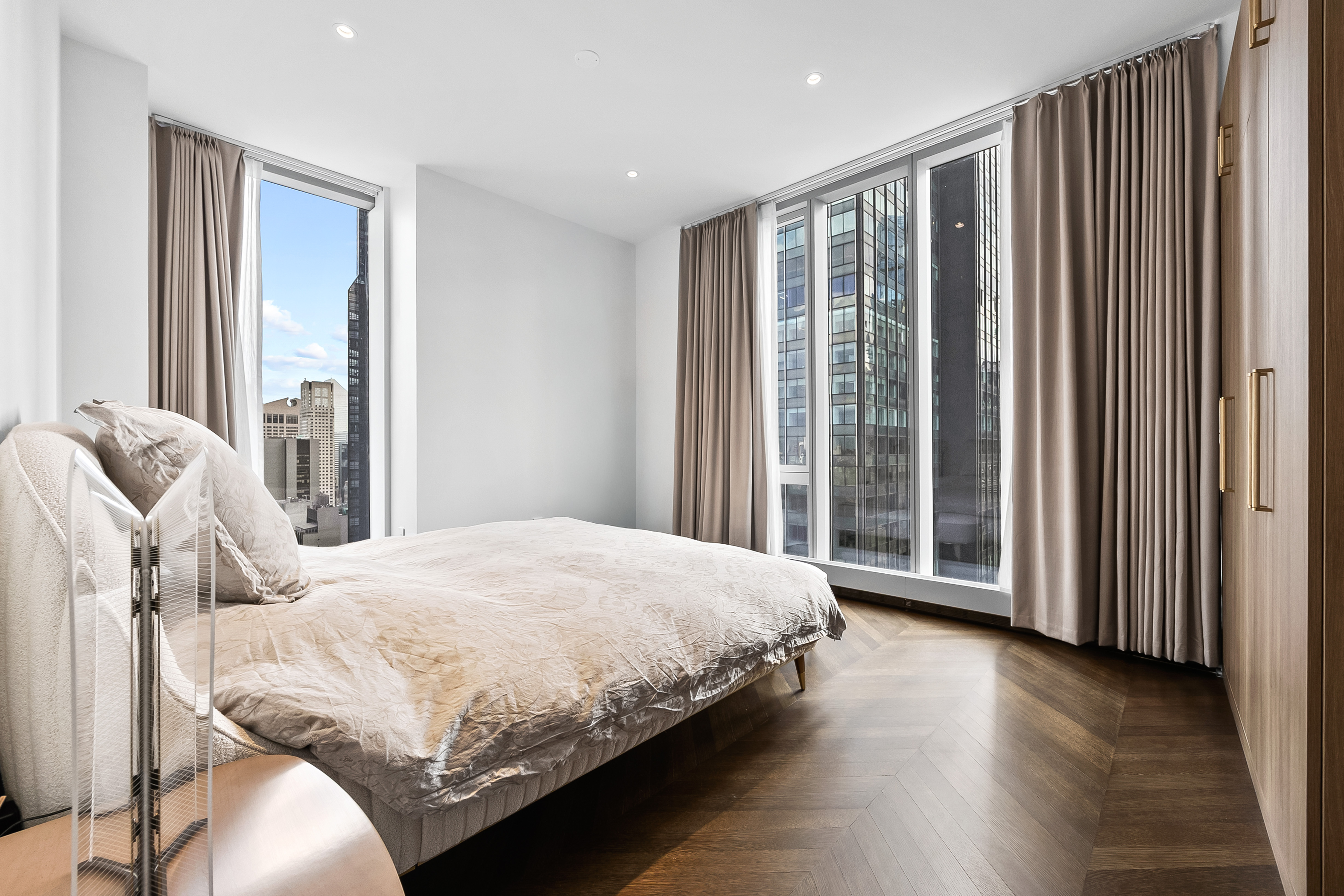 217 West 57th Street, Unit 36D Manhattan, NY 10019 - Photo 6 of 26 a bedroom with a large bed and a large window