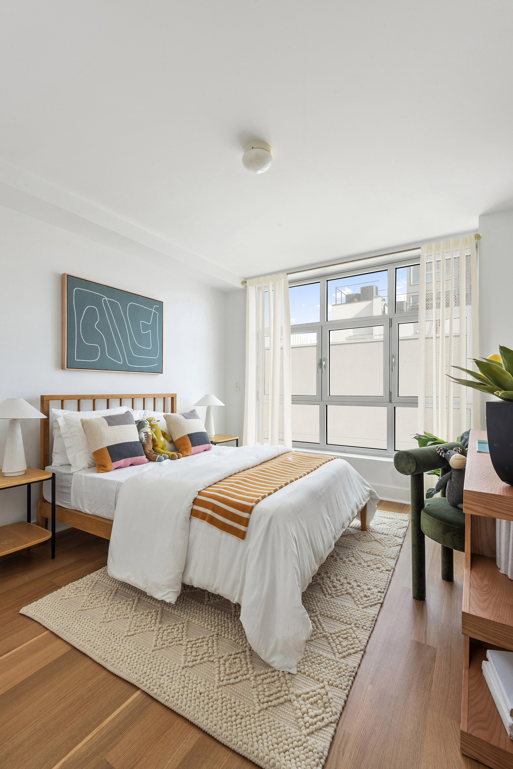 460 Manhattan Avenue, Unit PHB Brooklyn, NY 11222 - Photo 10 of 16 a bedroom with a large bed and a couch