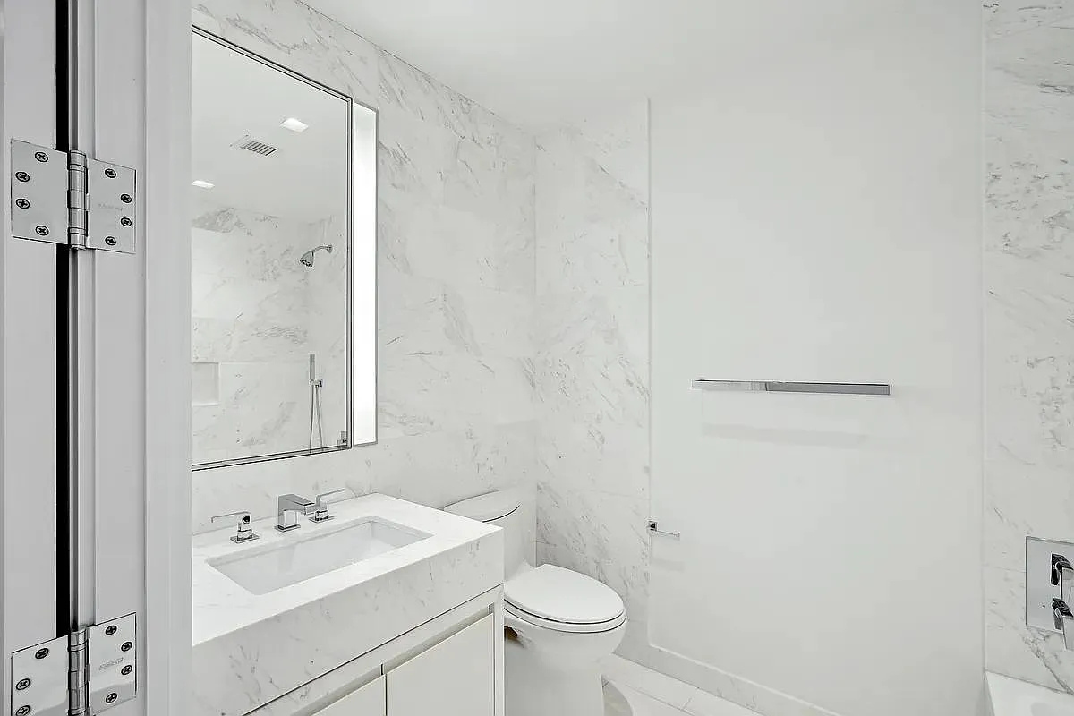 269 West 87th Street, Unit 9B Manhattan, NY 10024 - Photo 9 of 23 a bathroom with a sink a toilet and shower