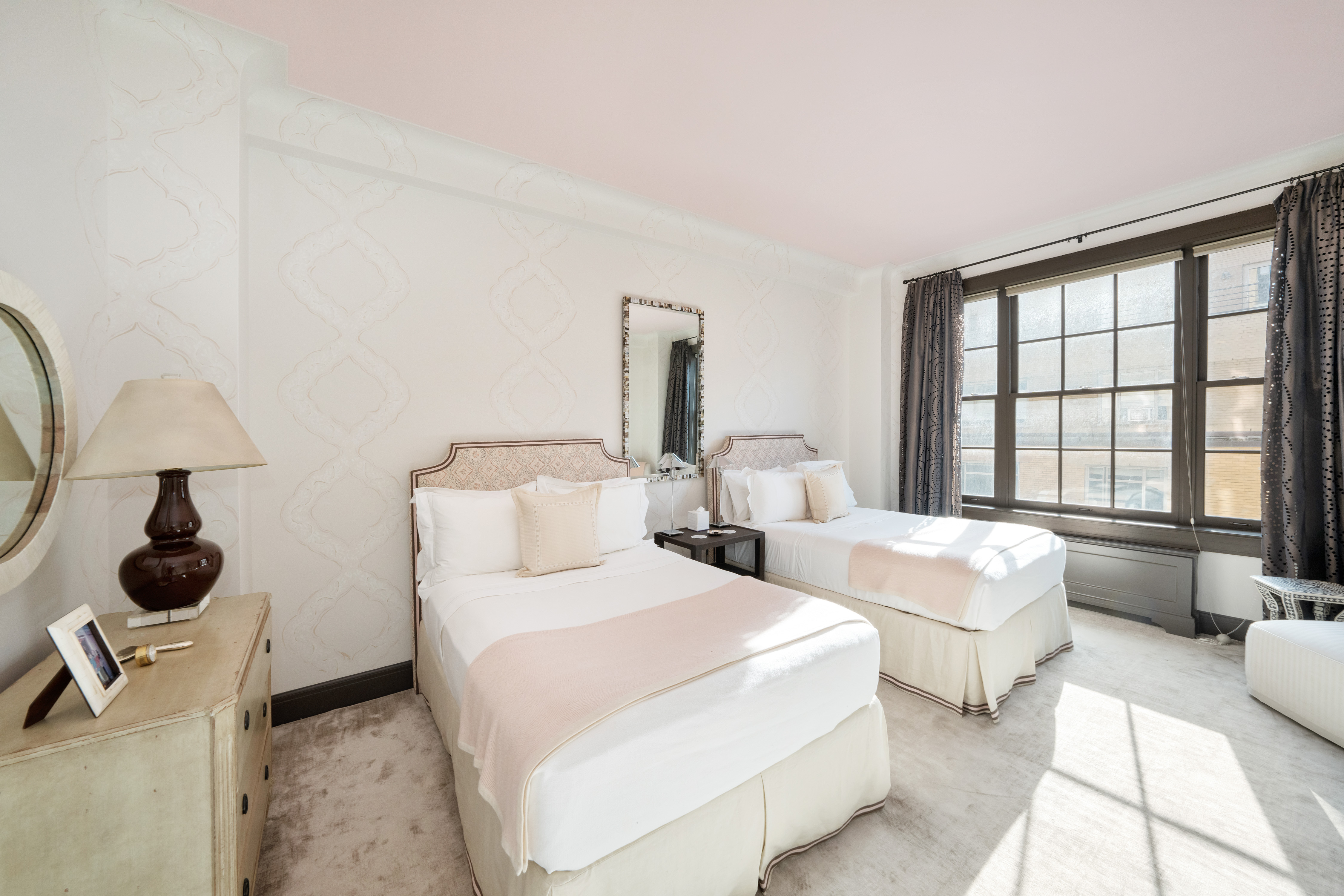 850 Park Avenue, Unit 9C Manhattan, NY 10075 - Photo 11 of 14 a bedroom with two beds and a large window