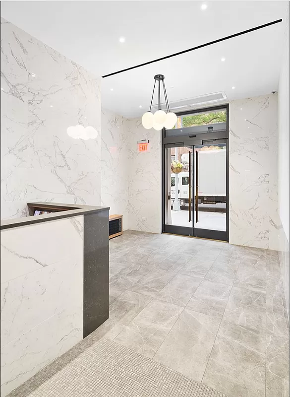 21 East 22nd Street, Unit 2A Manhattan, NY 10010 - Photo 8 of 10 a view of a hallway with a refrigerator