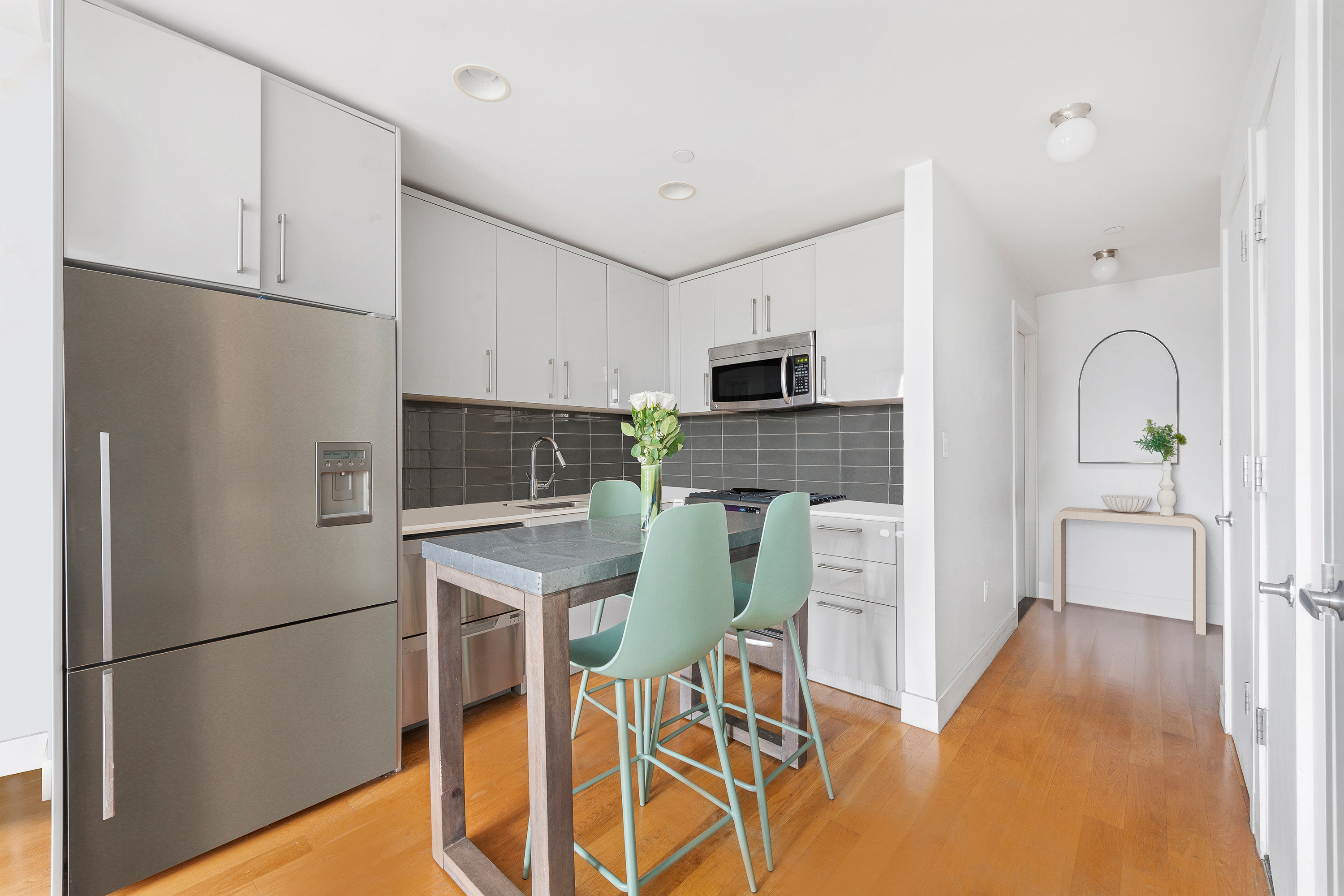 139 Skillman Avenue, Unit 7B Brooklyn, NY 11211 - Photo 3 of 12 a kitchen with stainless steel appliances a refrigerator stove microwave and cabinets