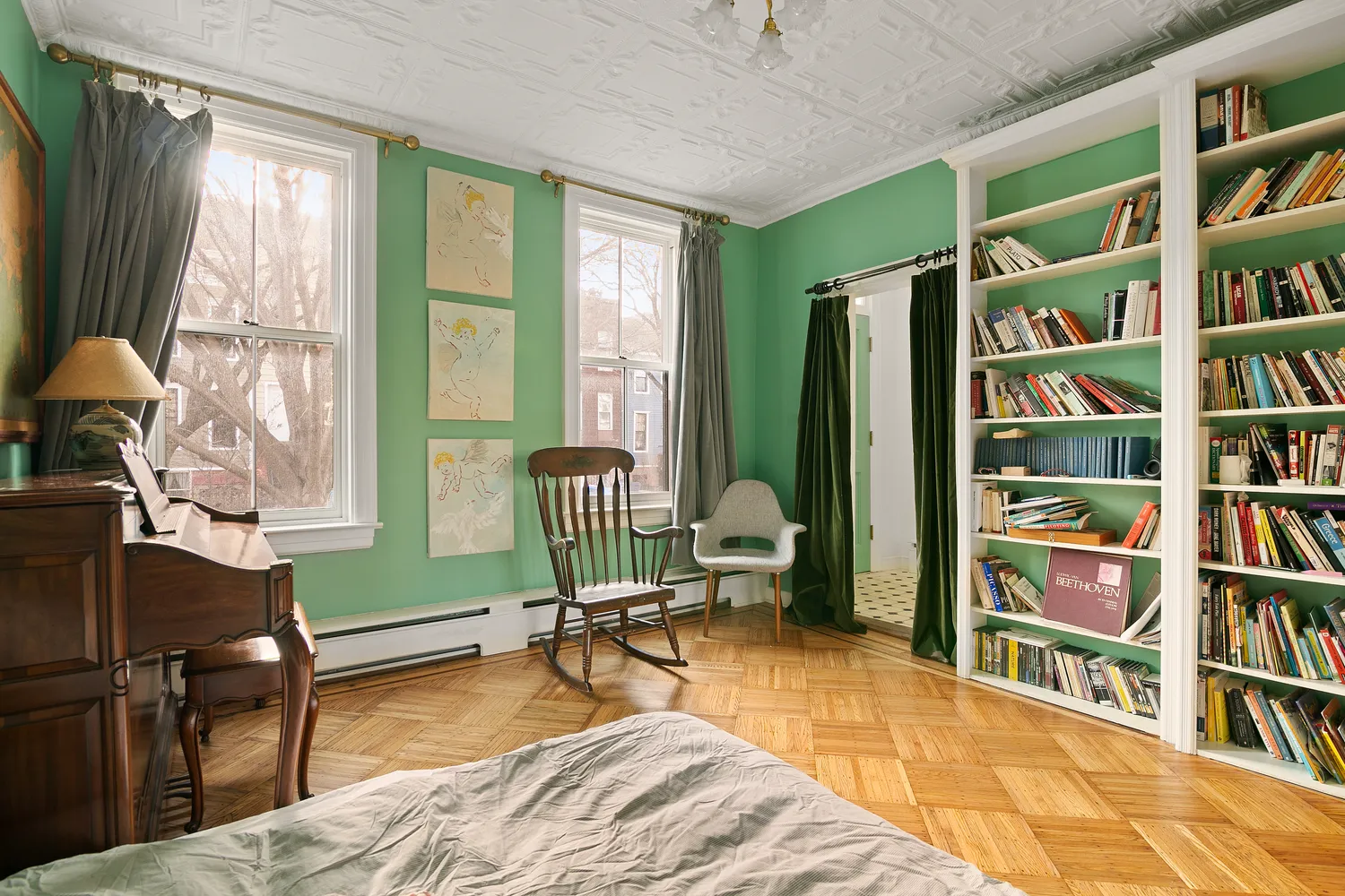 a bedroom with furniture and a book shelf