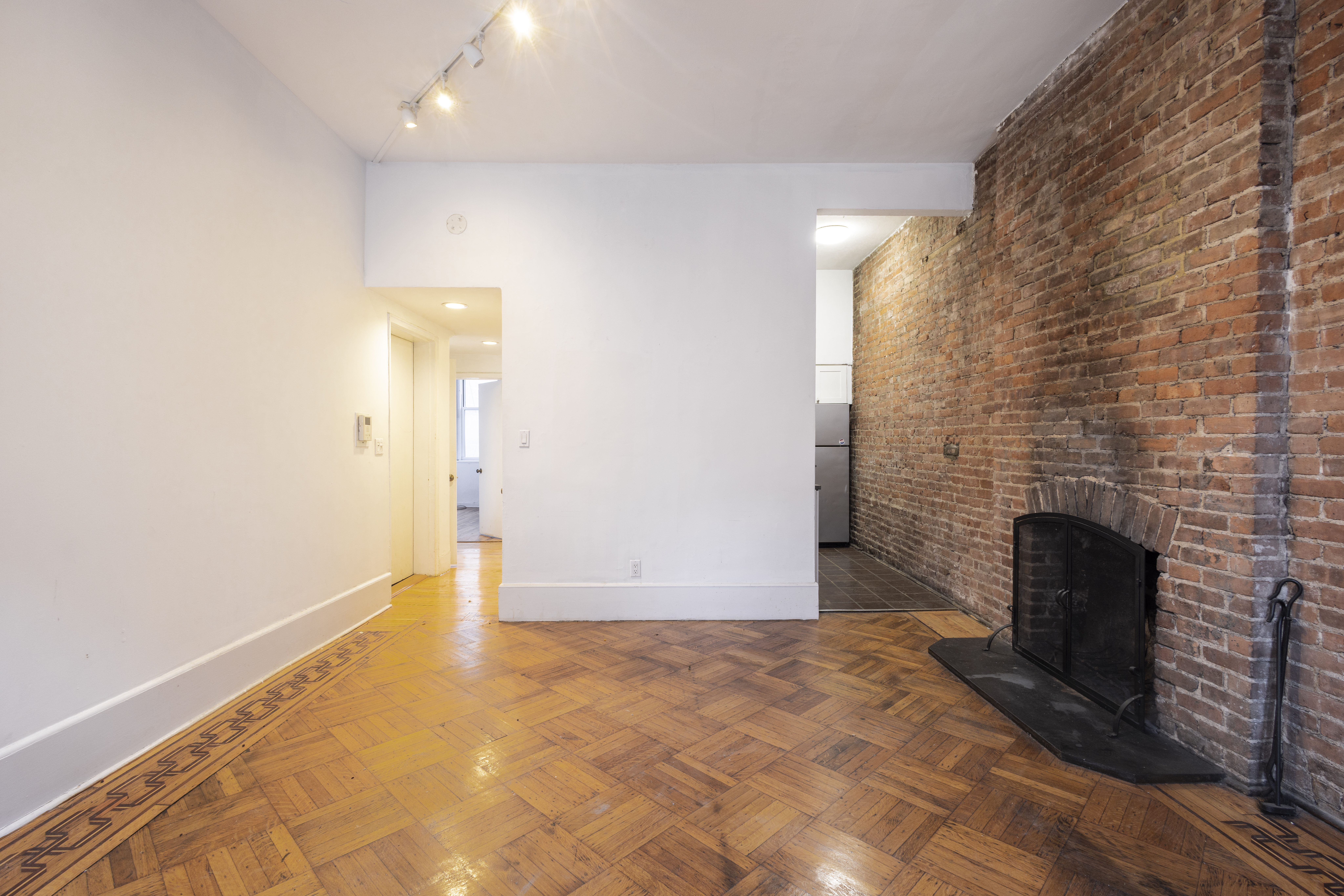 145 State Street, Unit 1 Brooklyn, NY 11201 - Photo 4 of 12 a view of empty room with fireplace and wooden floor