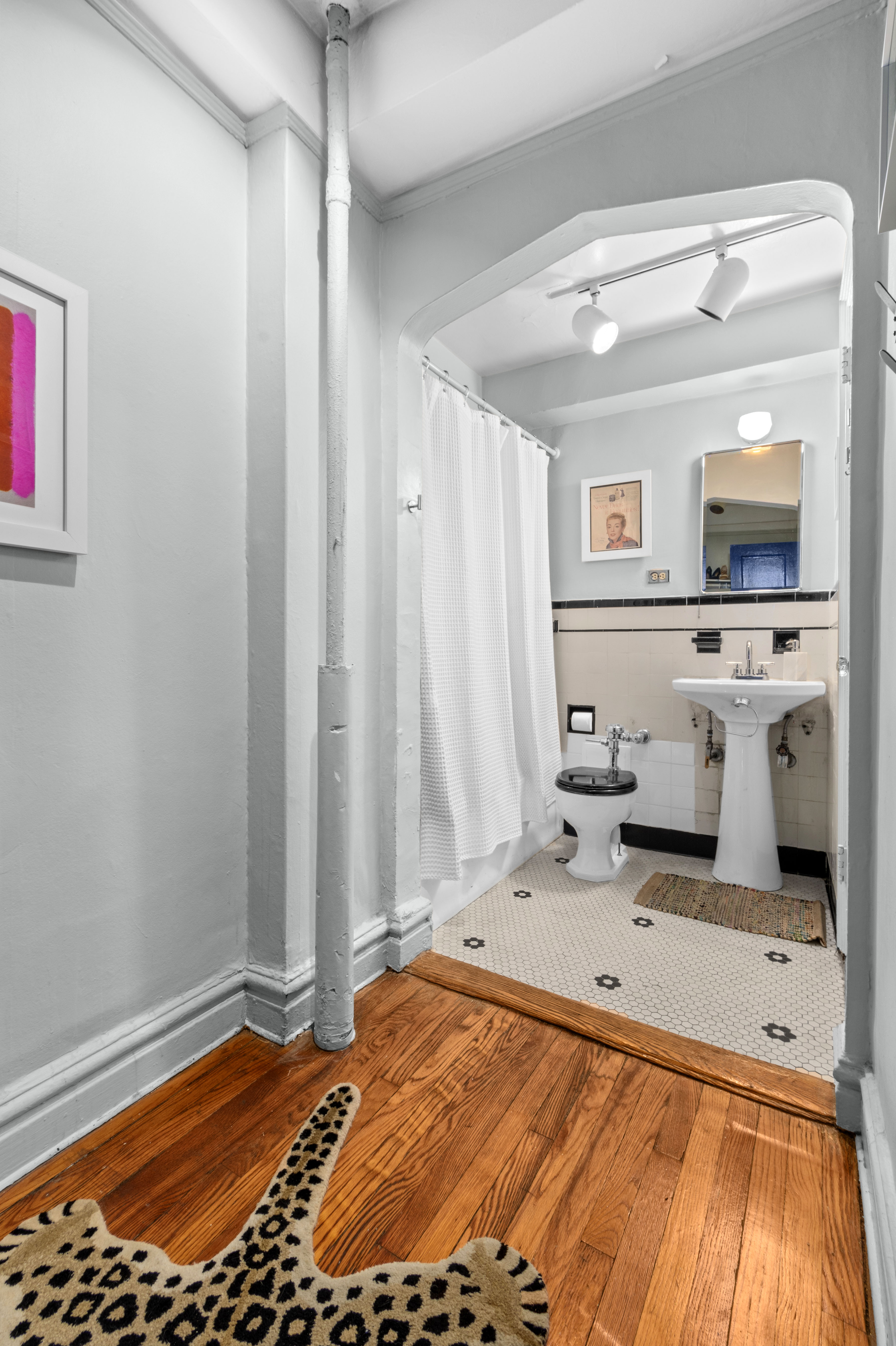 200 East 16th Street, Unit 2M Manhattan, NY 10003 - Photo 4 of 11 a bedroom with a bed and a view of bathroom