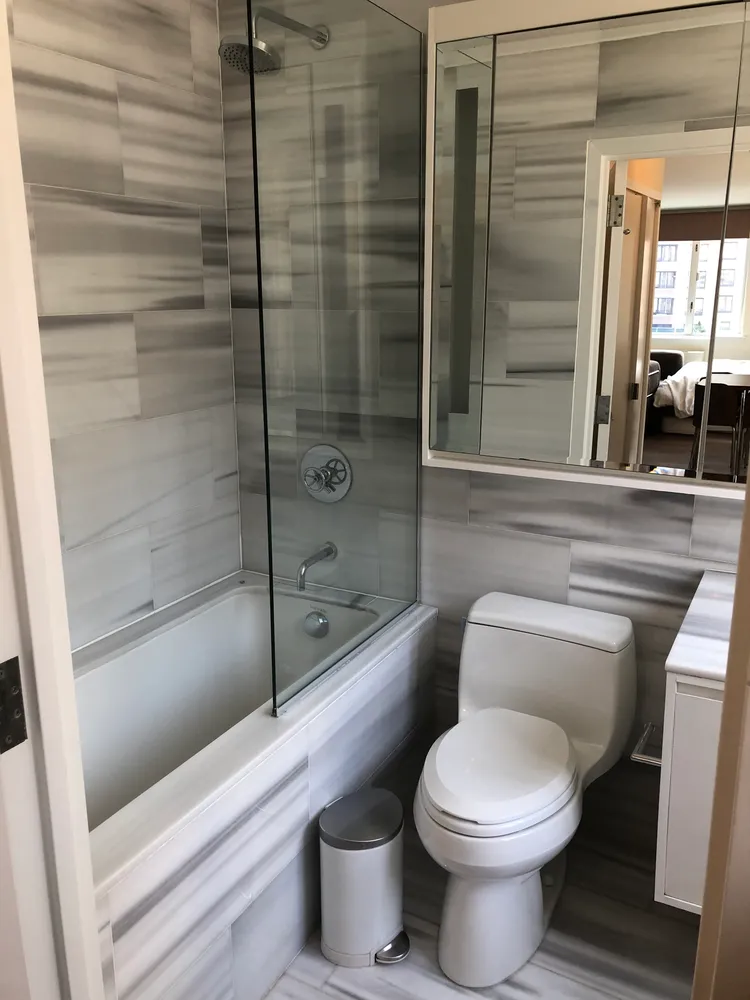 a bathroom with a toilet and a shower