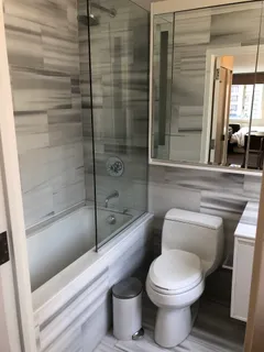 a bathroom with a toilet and a shower