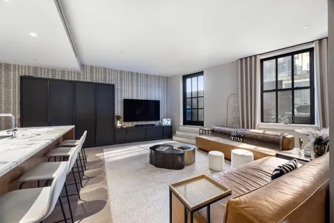 a living room with furniture a flat screen tv and a large window