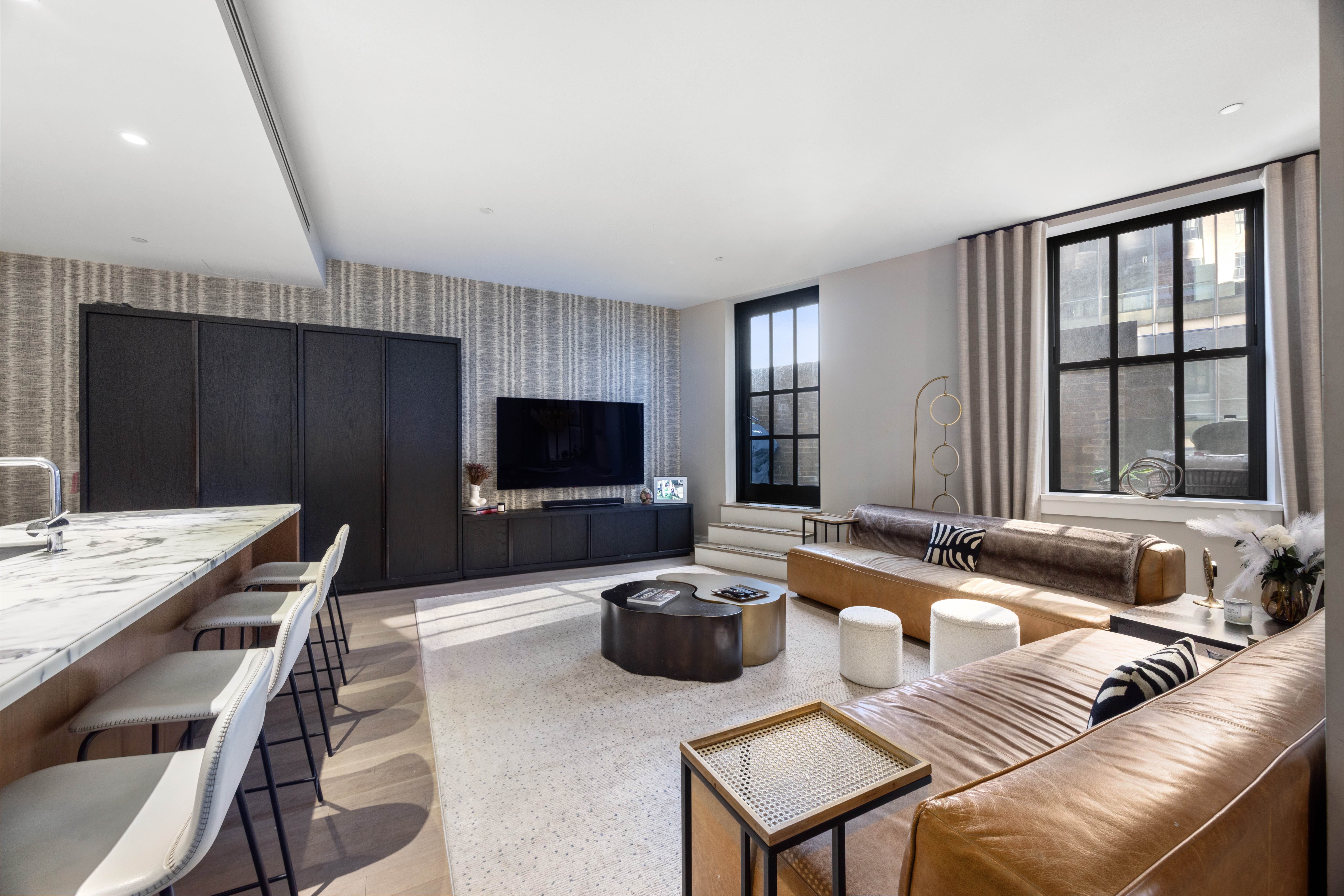 100 Barclay Street, Unit 16G Manhattan, NY 10007 - Photo 2 of 28 a living room with furniture a flat screen tv and a large window