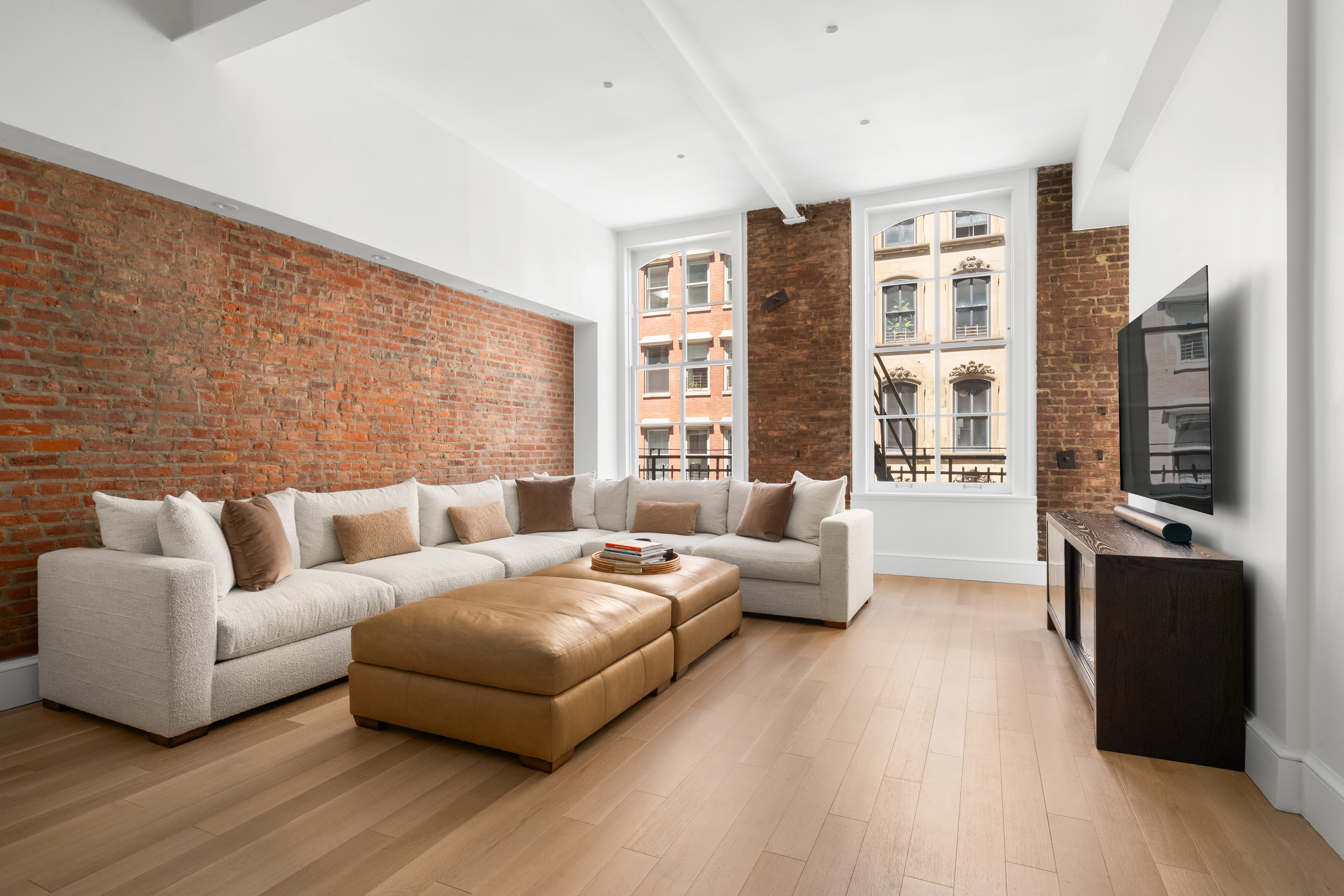51 Warren Street, Unit 3W Manhattan, NY 10007 - Photo 3 of 13 a living room with furniture large windows and wooden floor