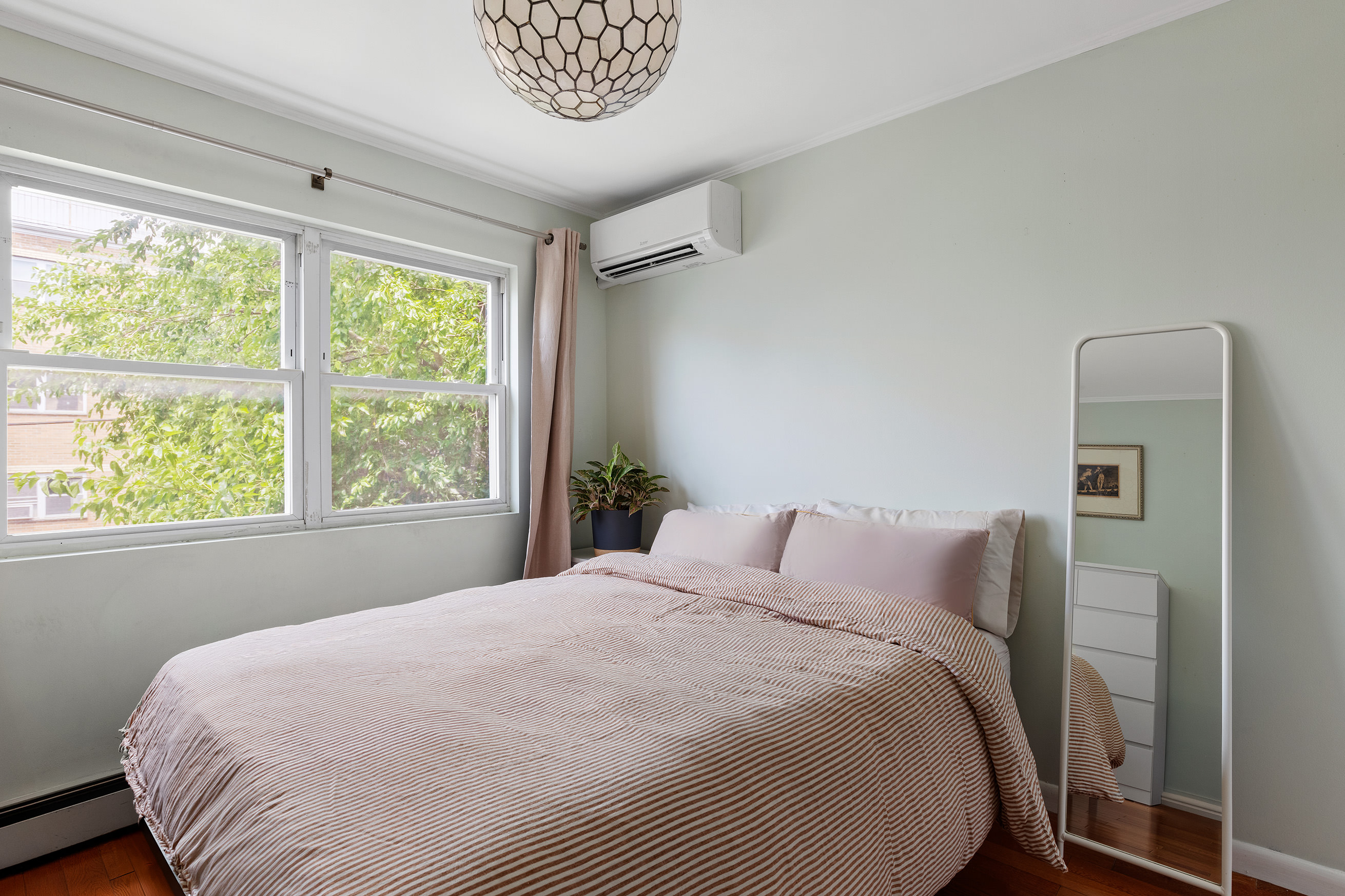 1427 Greene Avenue, Unit 2 Brooklyn, NY 11237 - Photo 6 of 9 a bedroom with a bed and a large window