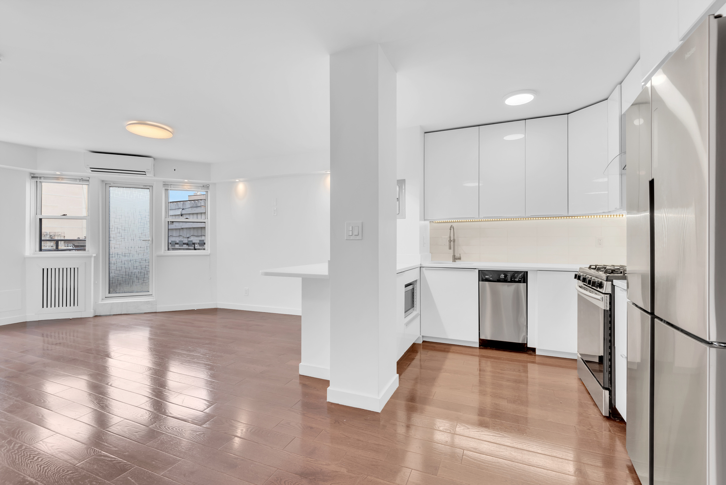 155 East 38th Street, Unit 18E Manhattan, NY 10016 - Photo 2 of 8 a view of a kitchen with a refrigerator a stove top oven and cabinets