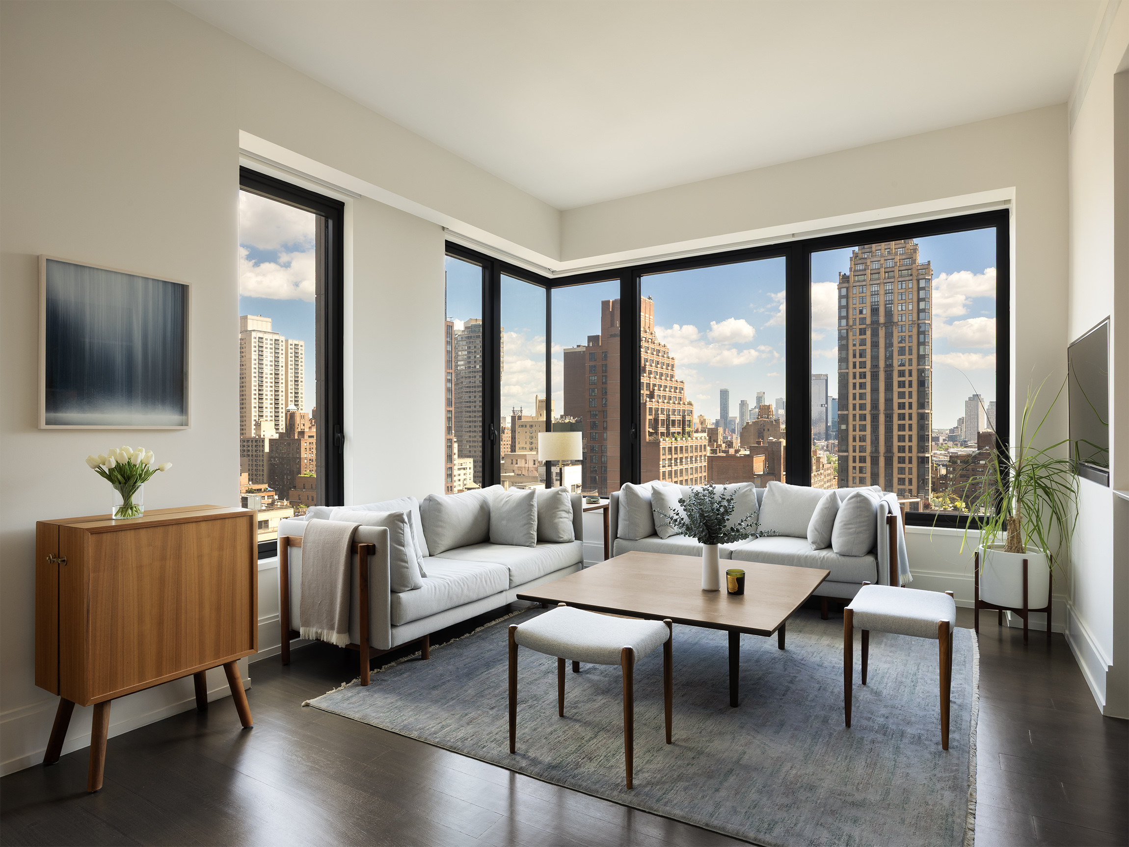 301 East 50th Street, Unit 16B Manhattan, NY 10022 - Photo 3 of 15 a living room with furniture and a large window