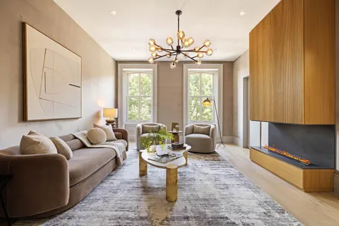 a living room with patio furniture and a chandelier