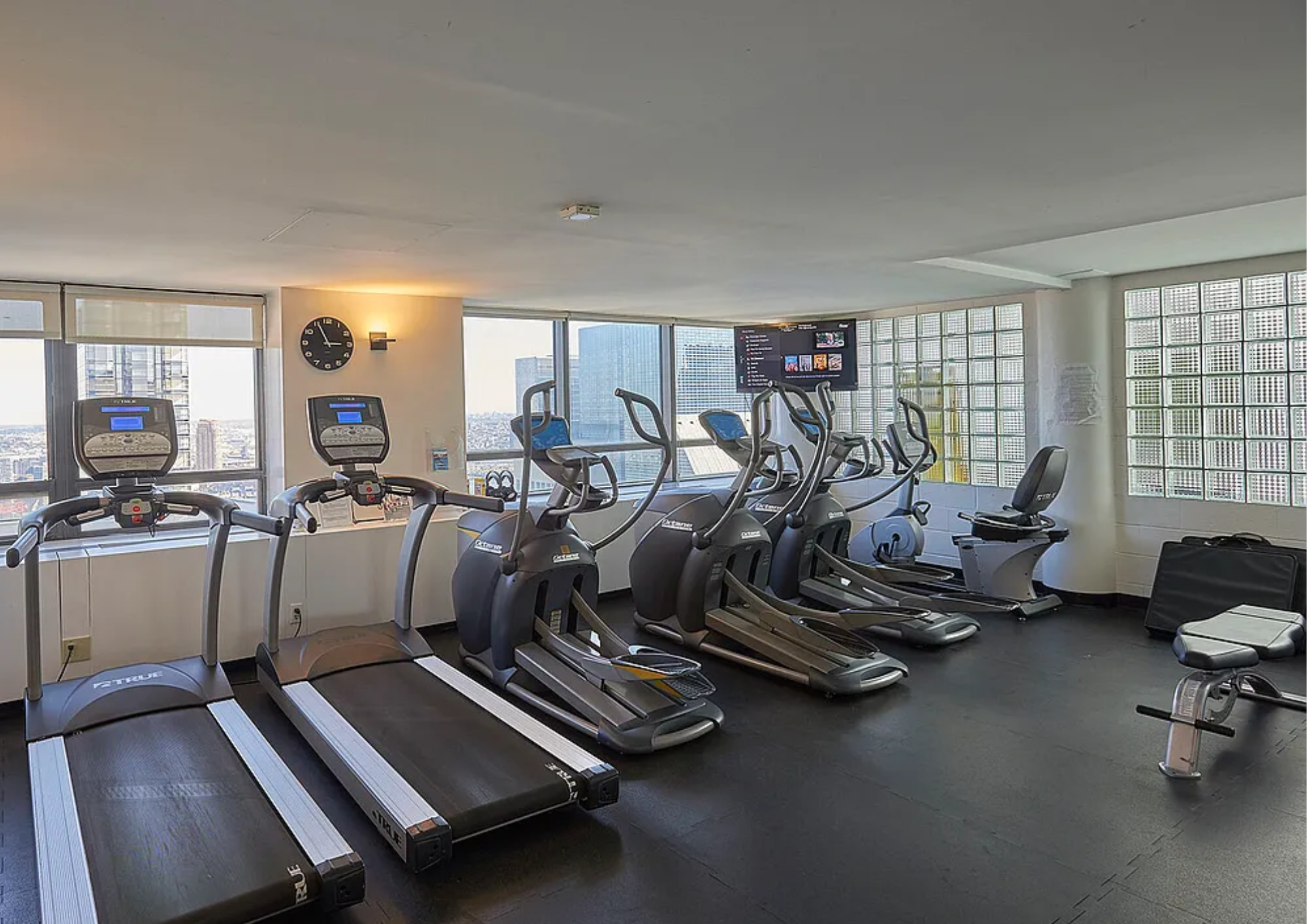 240 East 47th Street, Unit 4B Manhattan, NY 10017 - Photo 20 of 25 a room with gym equipment and a large window