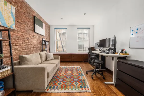 a living room with furniture rug and a window