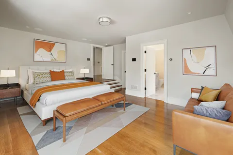 a bedroom with a bed and paintings on the wall