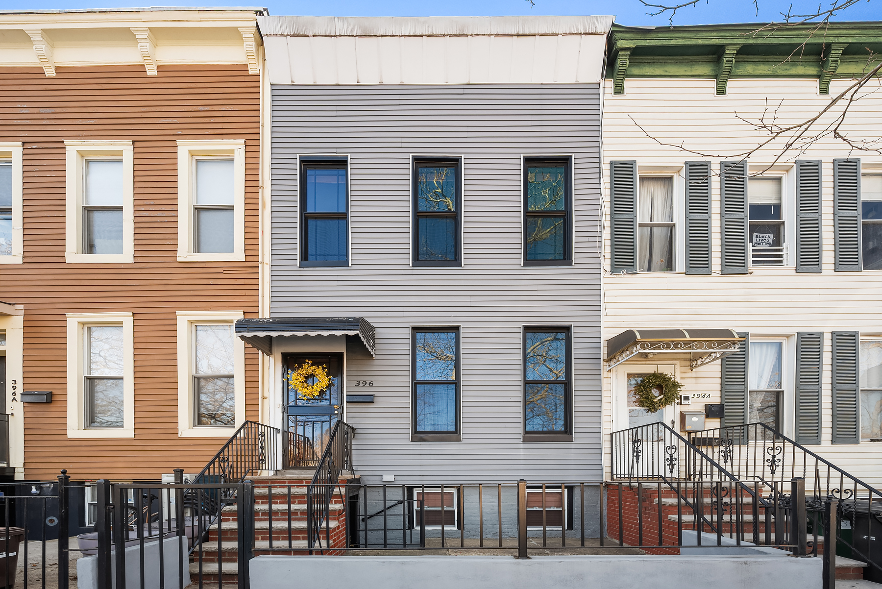 a front view of a residential apartment building with a glass windows