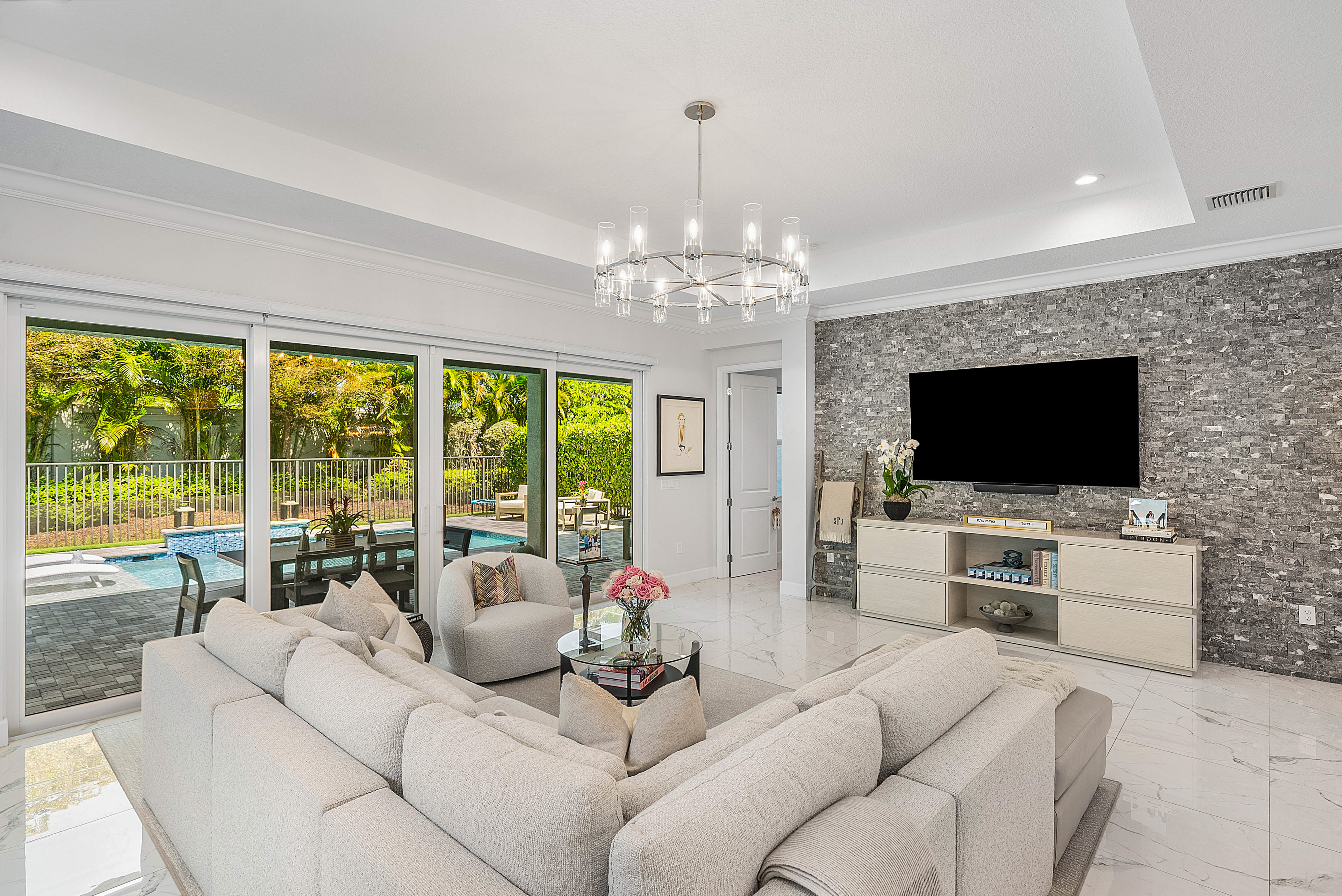 13172 Whistler Mountain Road Delray Beach, FL 33446 - Photo 12 of 38 a living room with furniture a flat screen tv and a large window