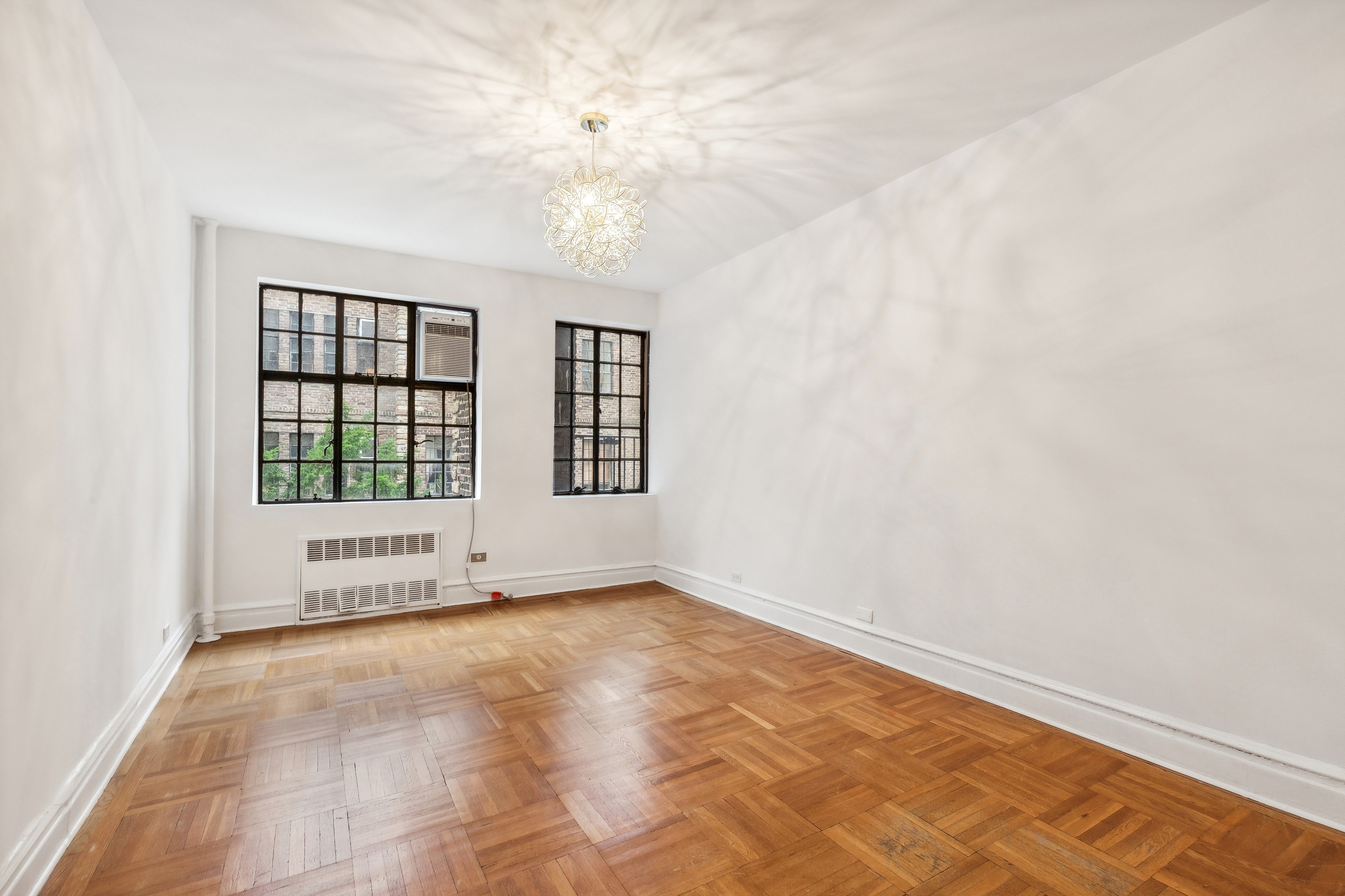 116 Pinehurst Avenue, Unit H32 Manhattan, NY 10033 - Photo 12 of 21 an empty room with windows
