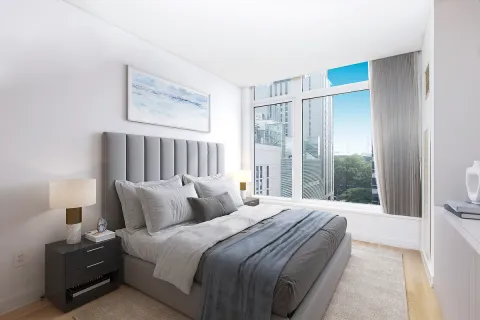 a bedroom with a large bed and a large window