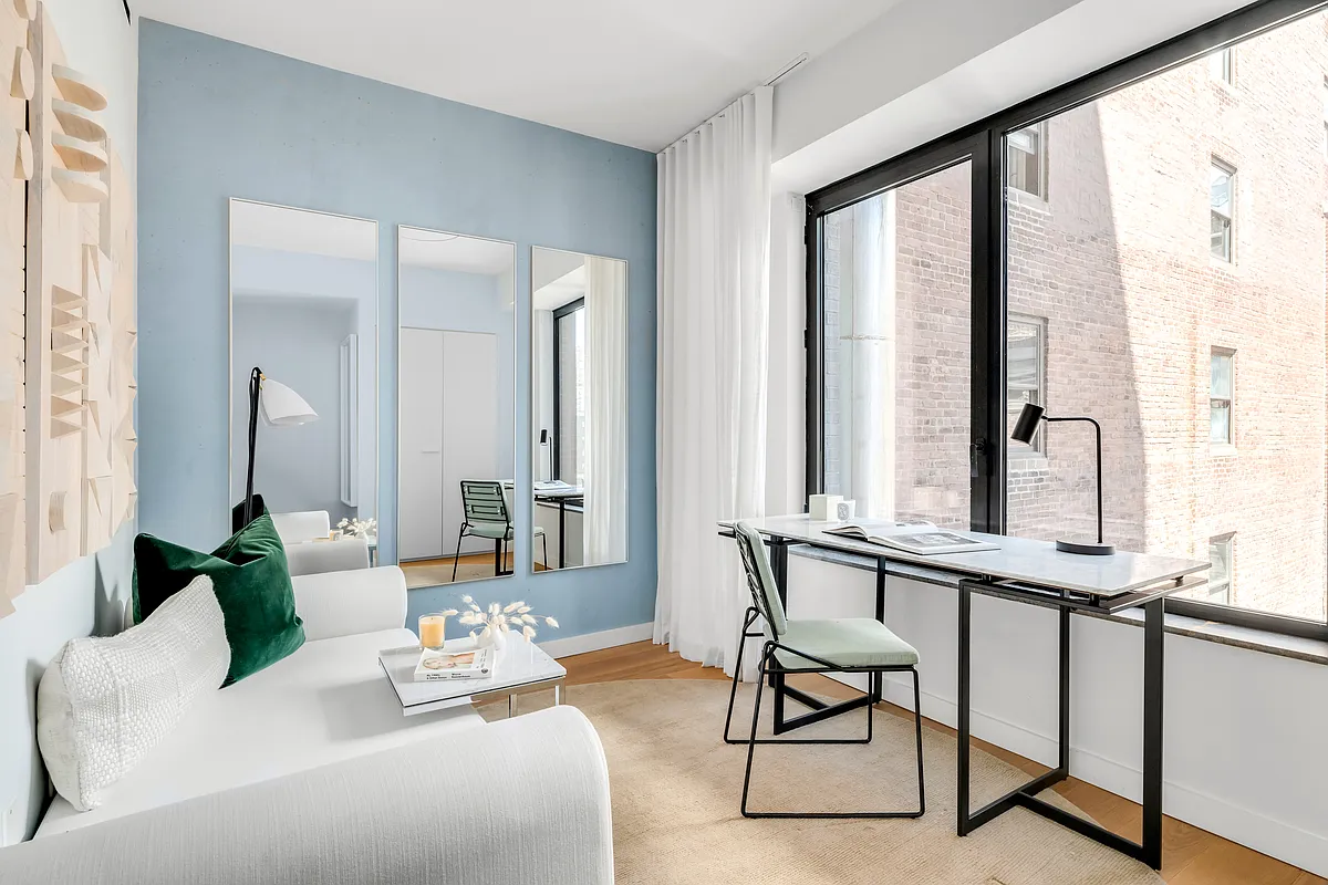 139 East 23rd Street, Unit 7 Manhattan, NY 10010 - Photo 12 of 17 a living room with furniture and large windows