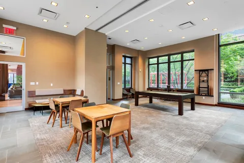 a living room with furniture a large window and a table