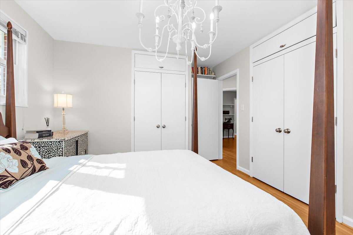 12712 Atherton Drive Silver Spring, MD 20906 - Photo 14 of 40 a bedroom with a bed and a chandelier