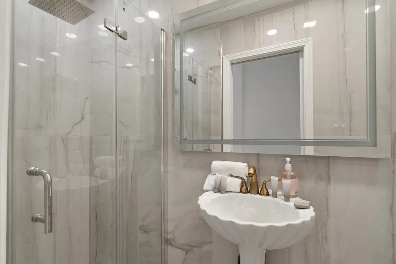 a bathroom with a sink a toilet and shower