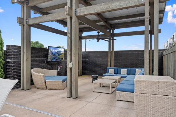 a patio with patio couch and a table