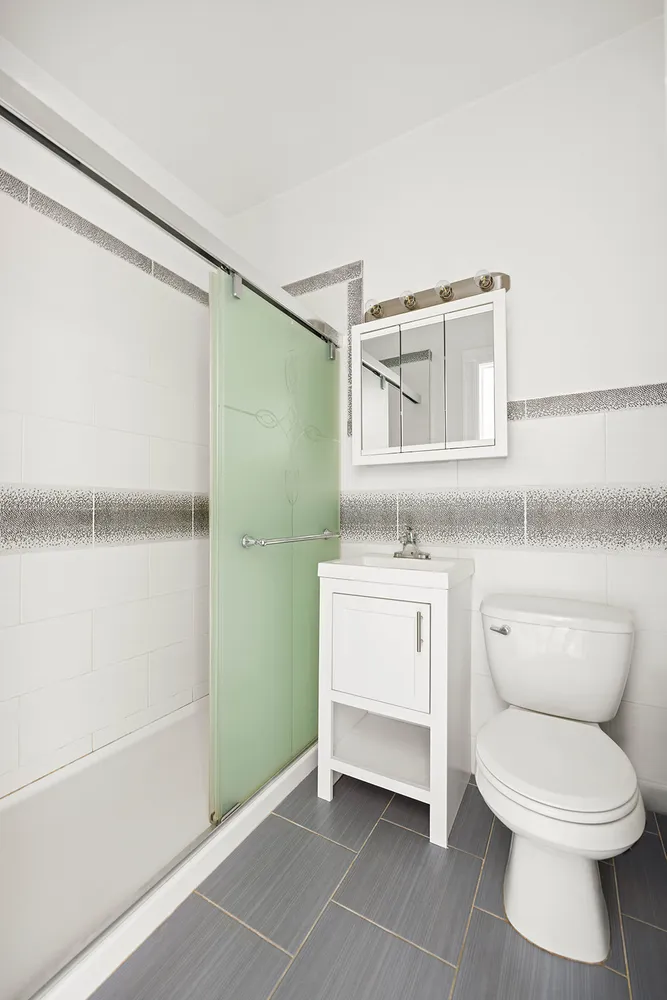 a bathroom with a toilet sink and shower