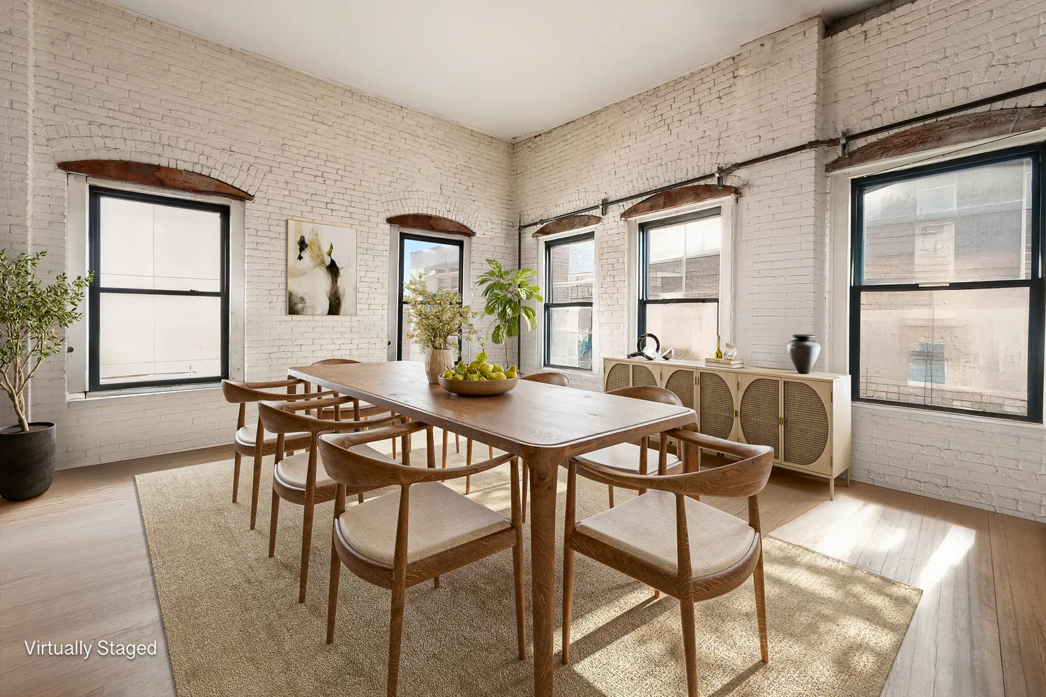 a view of a dining room with furniture and wooden floor