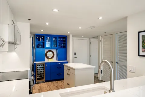a view of a kitchen with a table and a chair