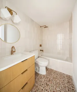a bathroom with a sink toilet and shower