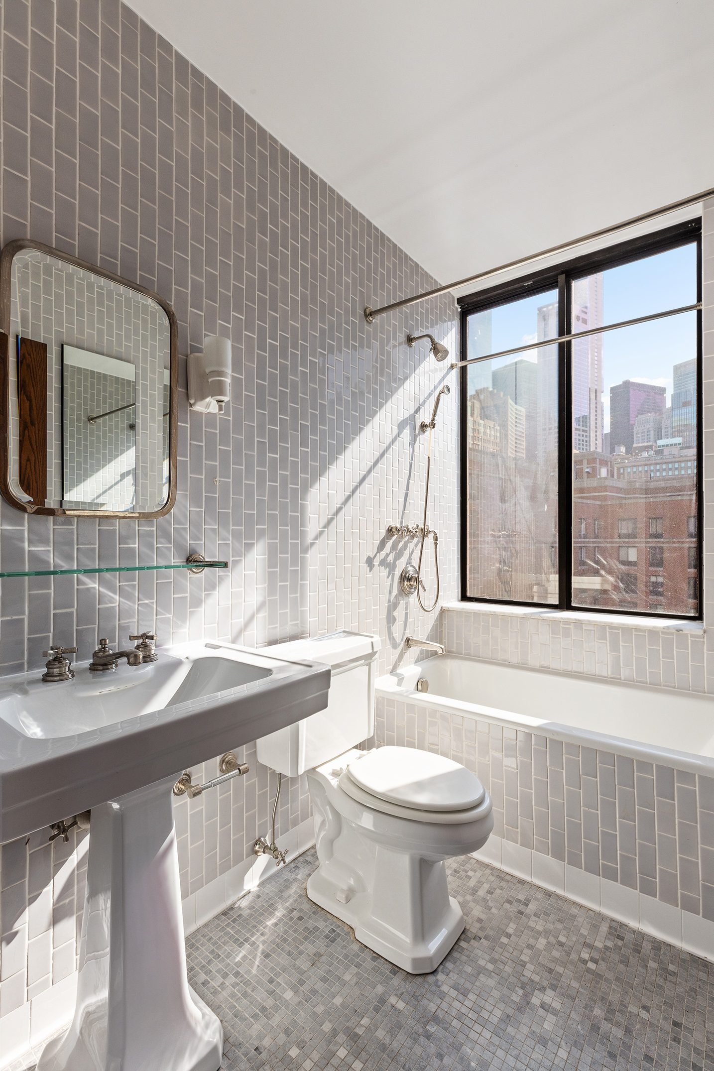 380 Rector Place, Unit 7LMN Manhattan, NY 10280 - Photo 10 of 14 a bathroom with a sink a toilet and mirror