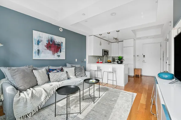 a living room with furniture and kitchen view