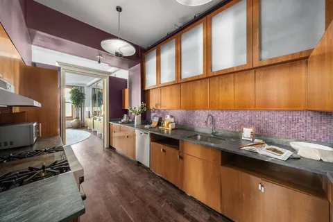 a kitchen with a sink and a stove top oven