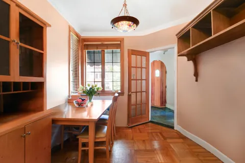 a view of a dining room with furniture and wooden floor