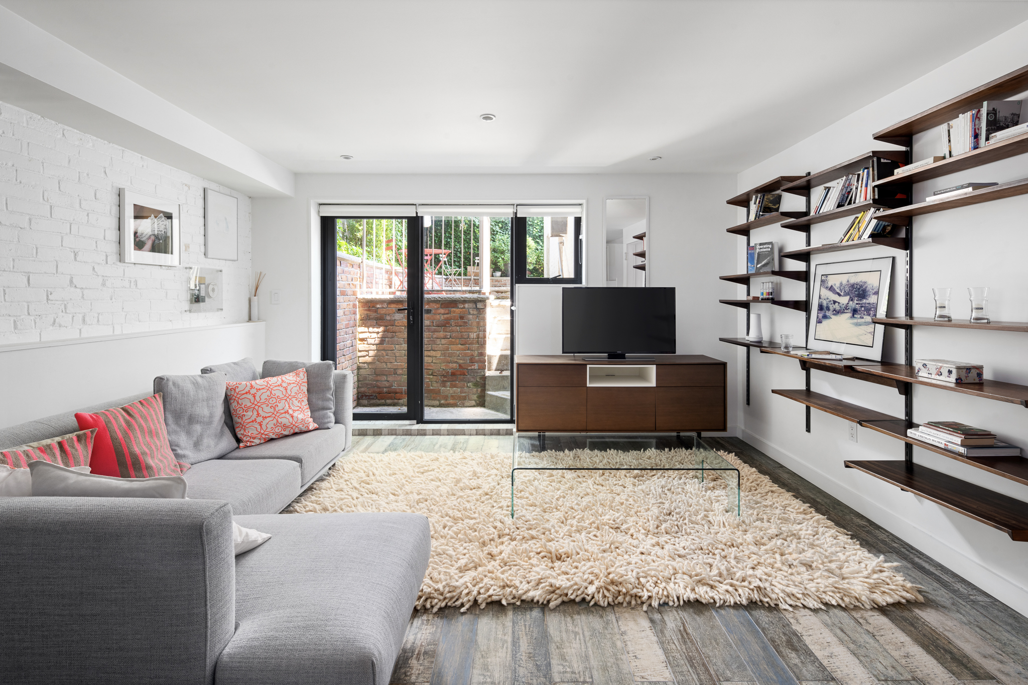 512 Lorimer Street Brooklyn, NY 11211 - Photo 17 of 22 a living room with furniture and a flat screen tv