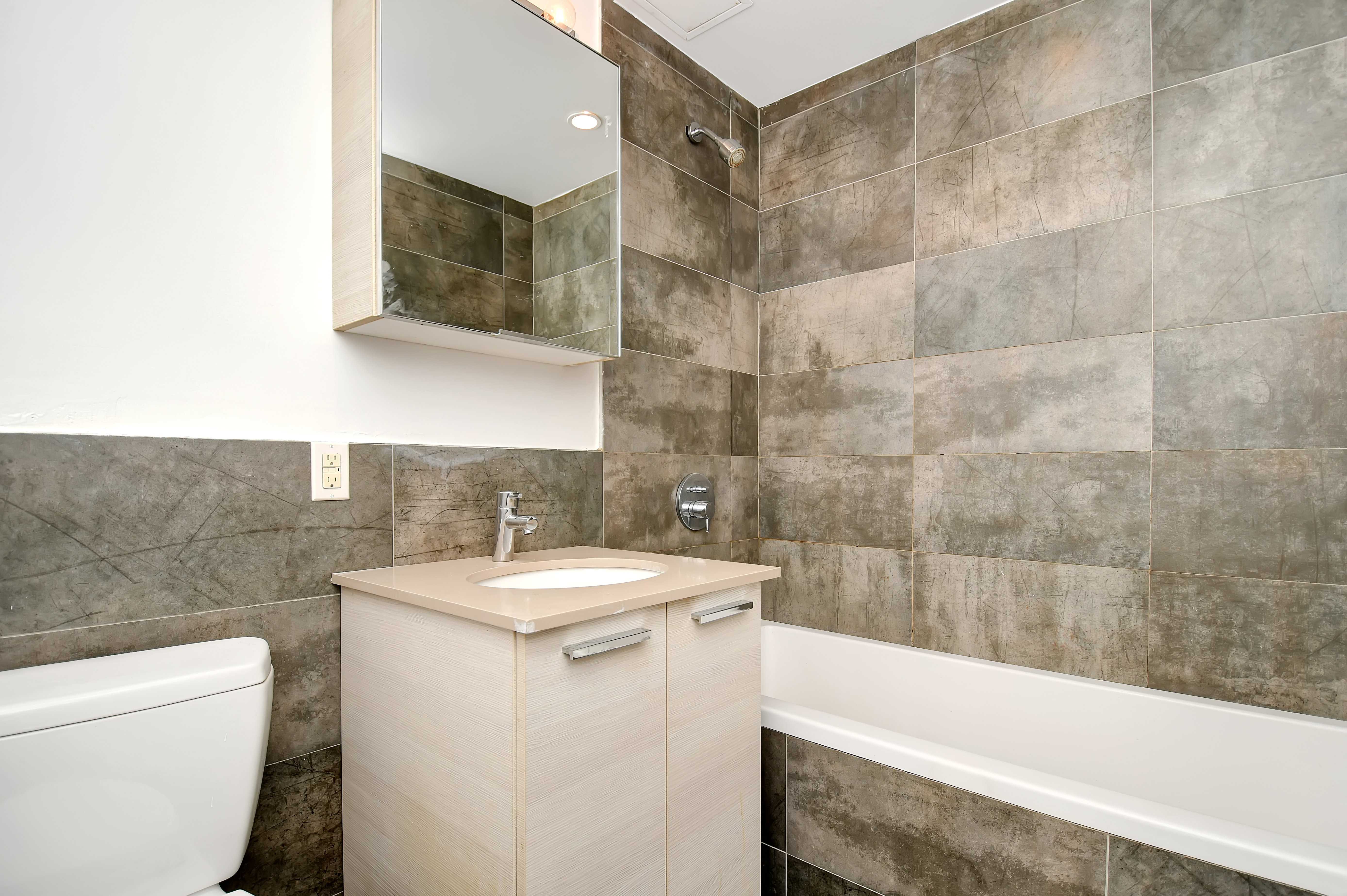 281 Union Avenue, Unit PHJ Brooklyn, NY 11211 - Photo 5 of 8 a bathroom with a sink a toilet and shower