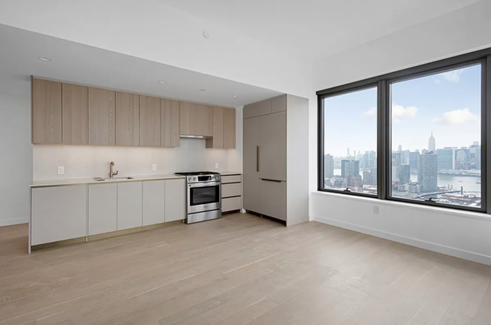 3 Court Square, Unit 1902 Queens, NY 11101 - Photo 3 of 16 a view of a kitchen with furniture and an empty room