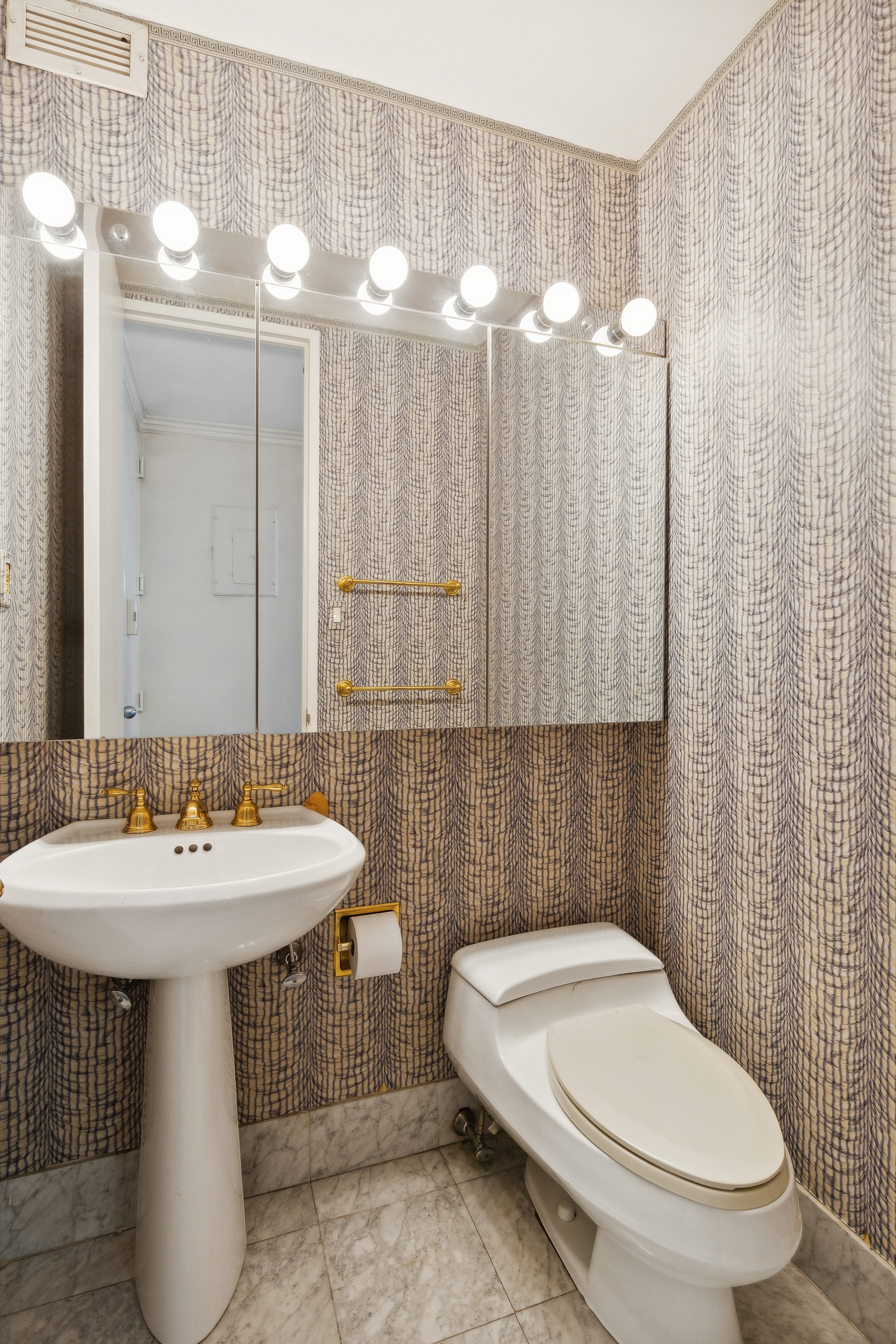 235 East 40th Street, Unit 37C Manhattan, NY 10016 - Photo 6 of 10 a bathroom with a sink a toilet and a mirror