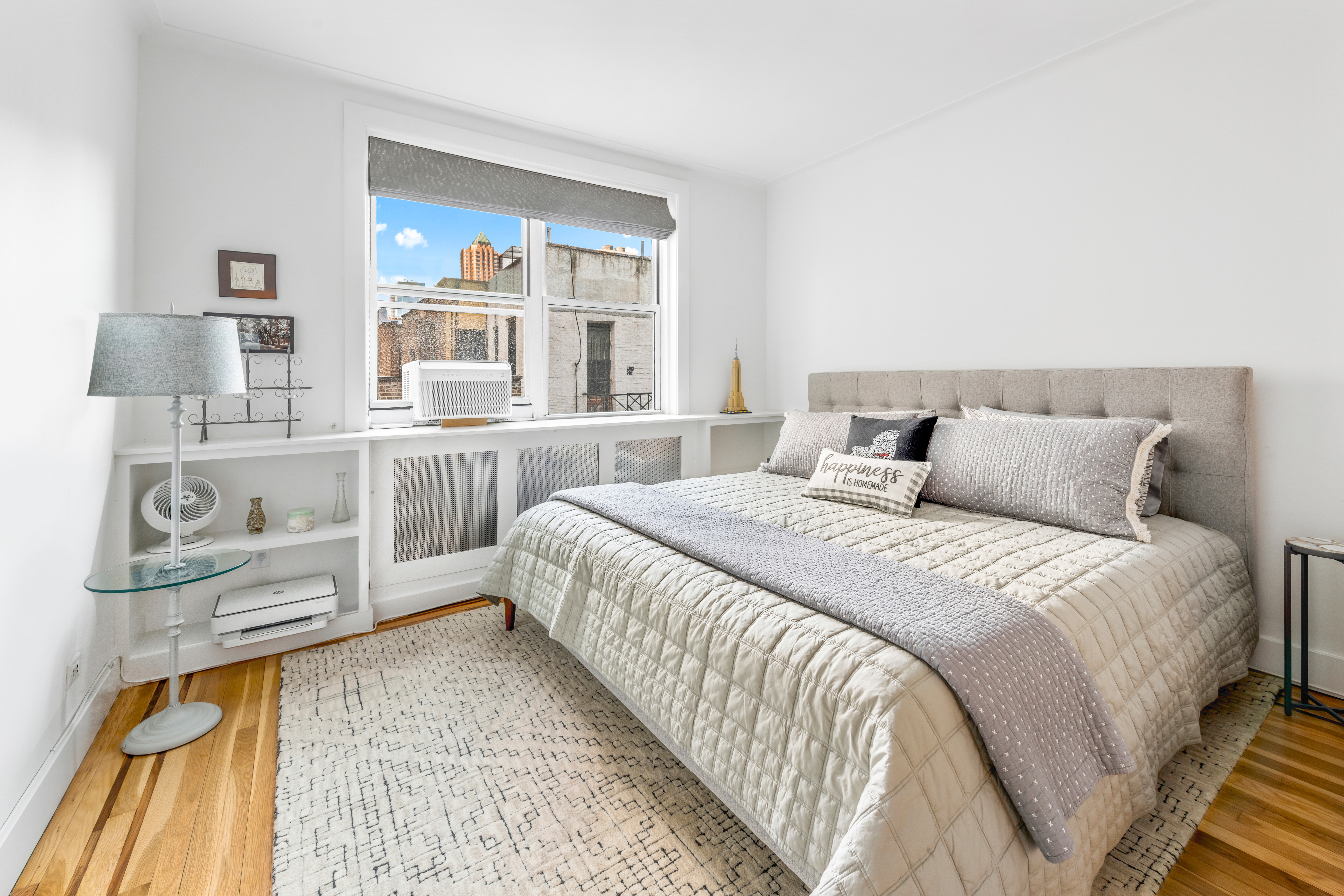 310 West 55th Street, Unit 5K Manhattan, NY 10019 - Photo 5 of 9 a bedroom with a bed and a cabinets