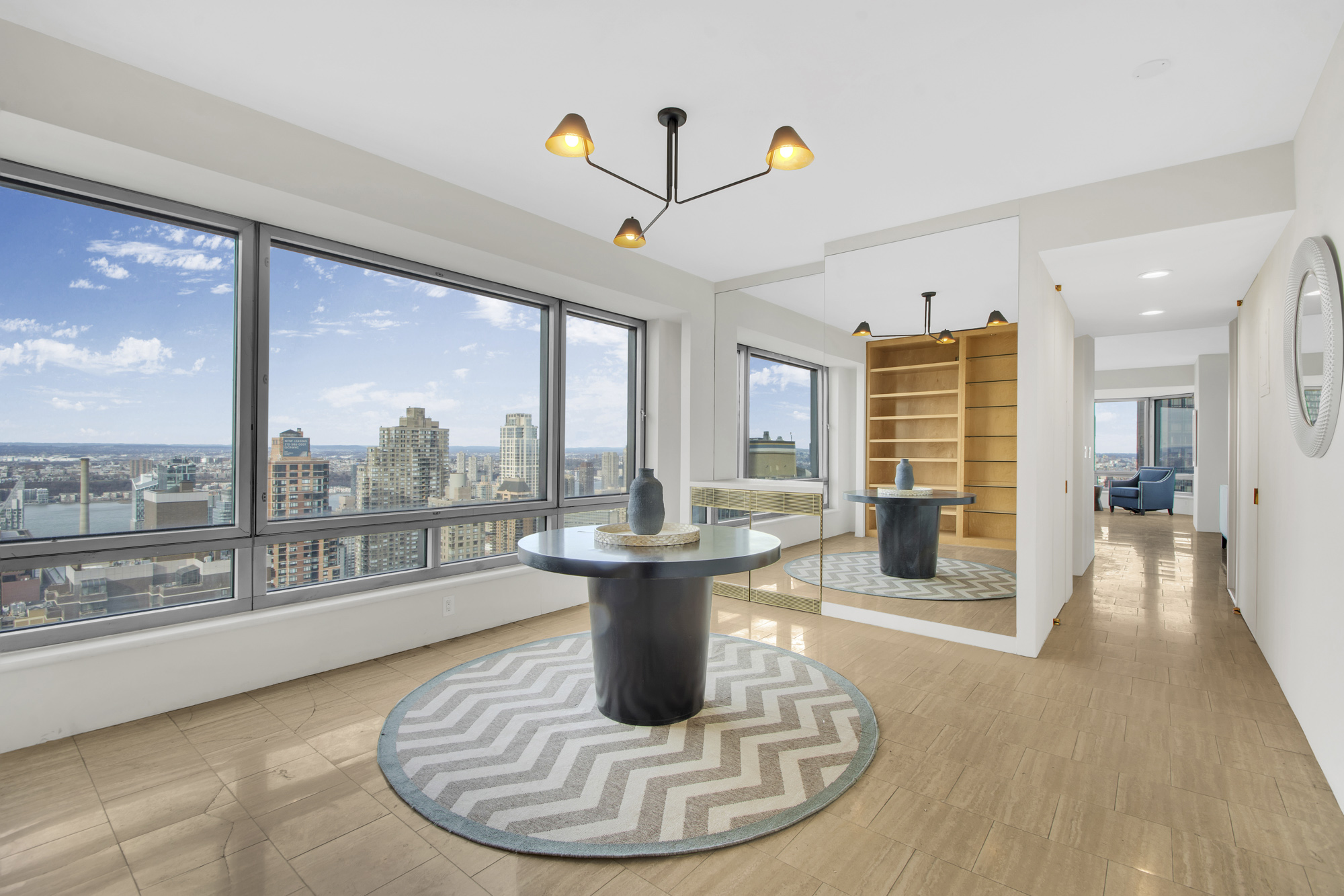 301 West 57th Street, Unit 48A Manhattan, NY 10019 - Photo 13 of 22 a view of a living room and a floor to ceiling window