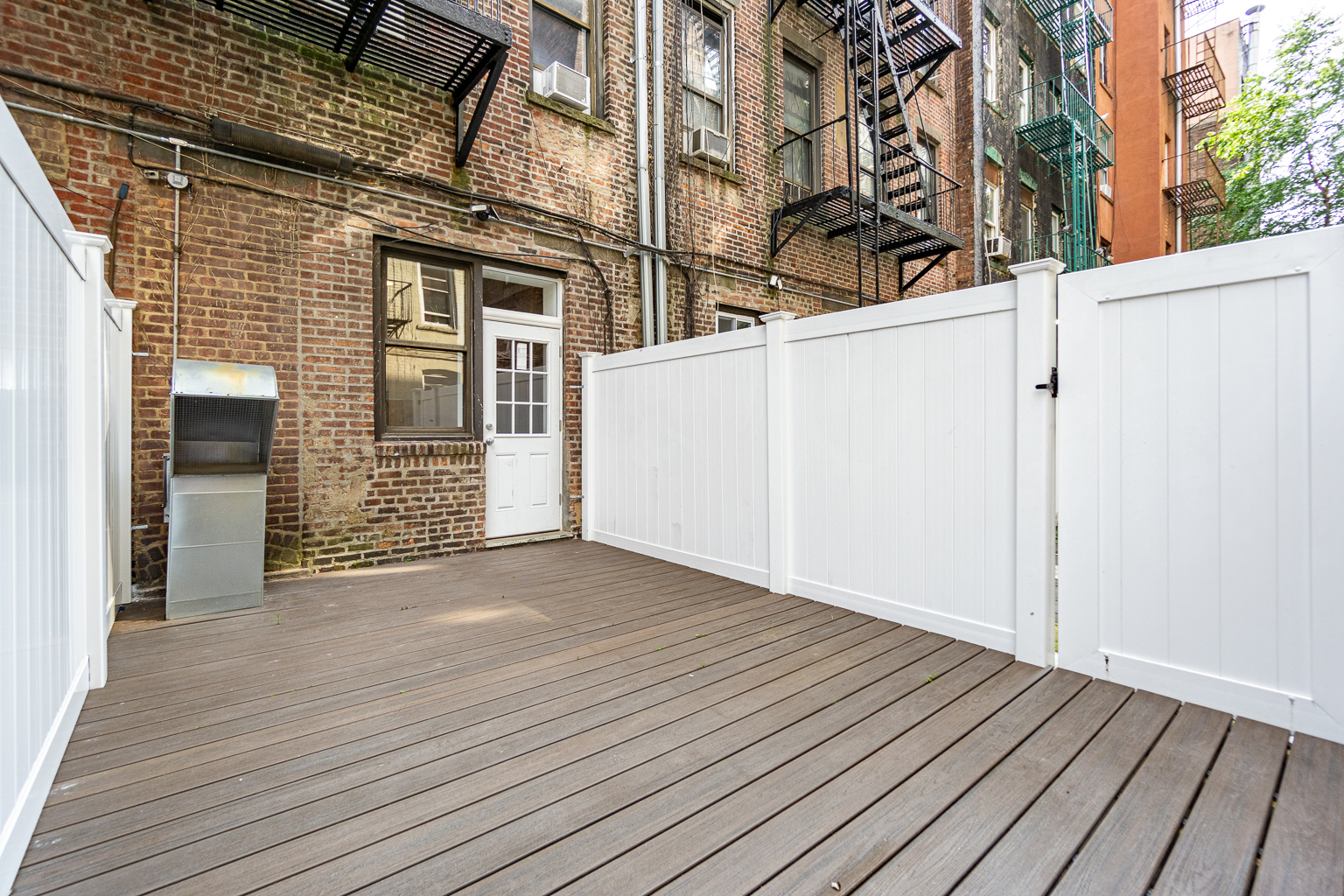339 East 6th Street, Unit B Manhattan, NY 10003 - Photo 4 of 22 an empty room with wooden floor and windows