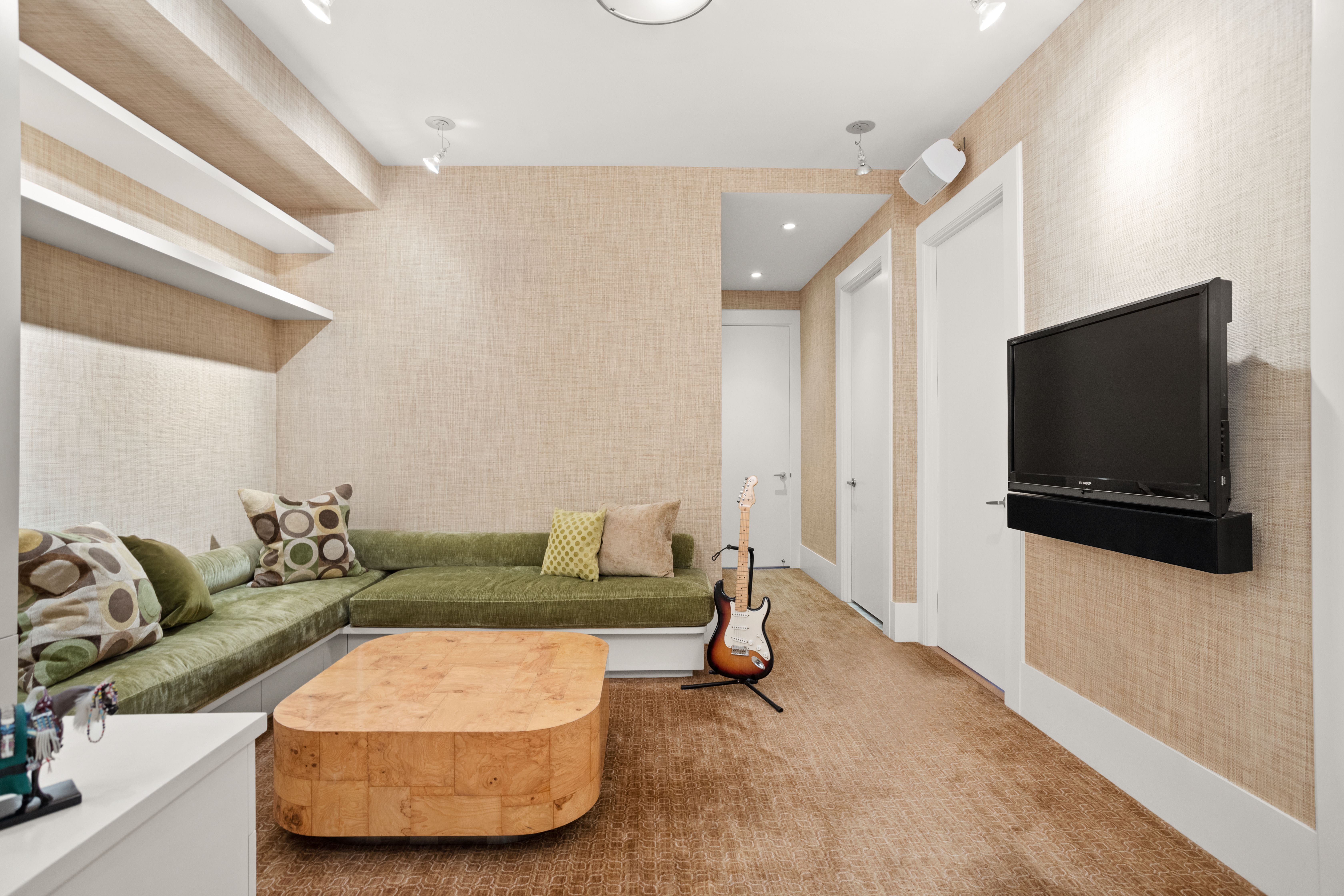 255 East 74th Street, Unit 21AB Manhattan, NY 10021 - Photo 15 of 37 a living room with furniture and a flat screen tv