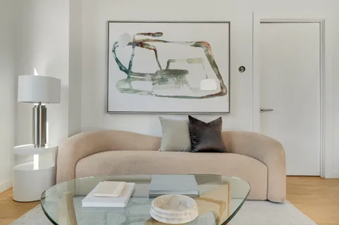 a living room with furniture and a mirror