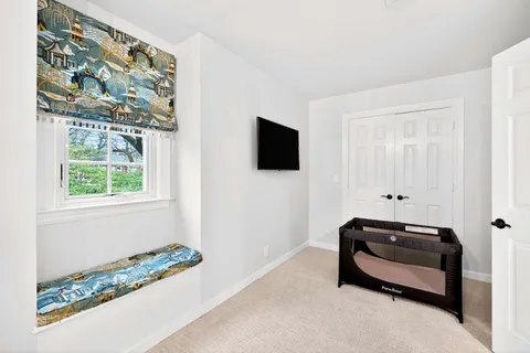 a room with a bed and a flat screen tv